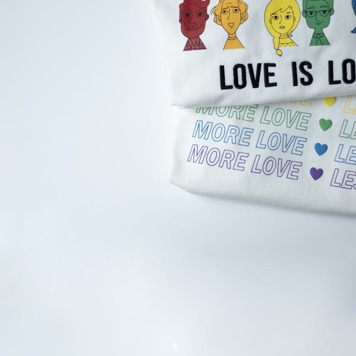 LGBTQ-themed t-shirts featuring diversity and love messages on a white background.